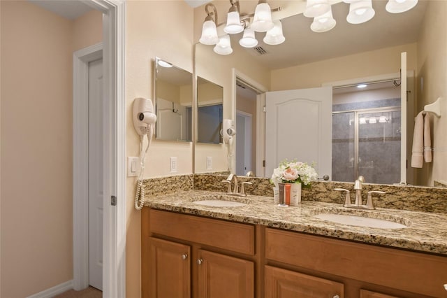 bathroom with a shower with door and vanity