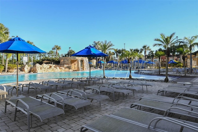 view of swimming pool featuring pool water feature and a patio