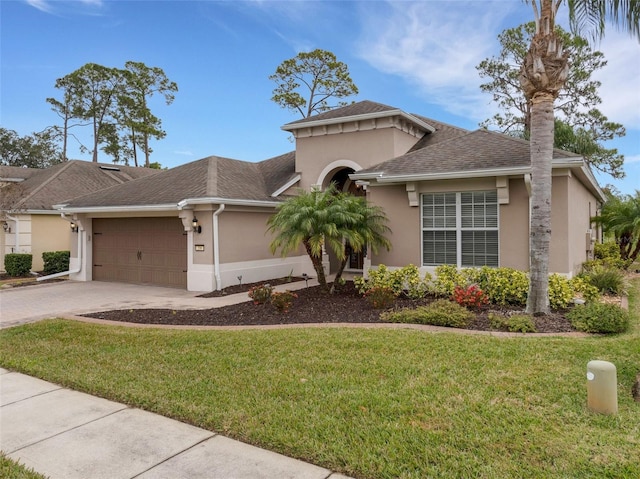 view of front of property featuring a garage and a front yard