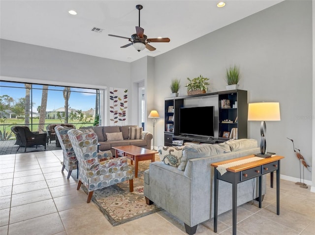 tiled living room with ceiling fan