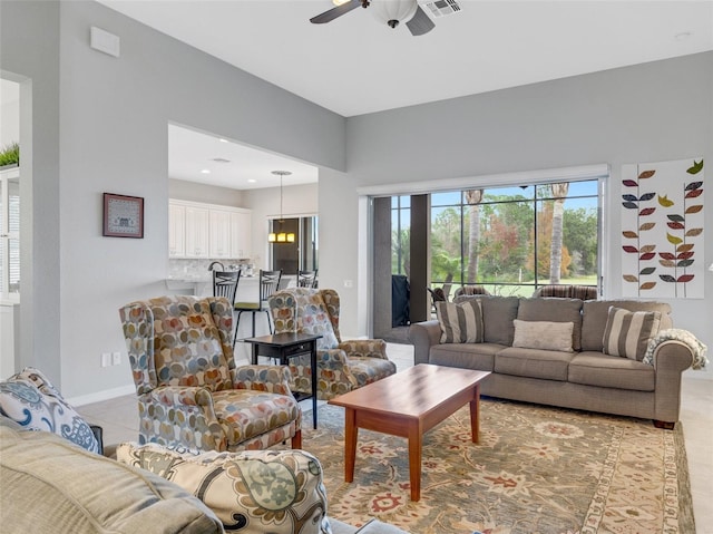 tiled living room with ceiling fan