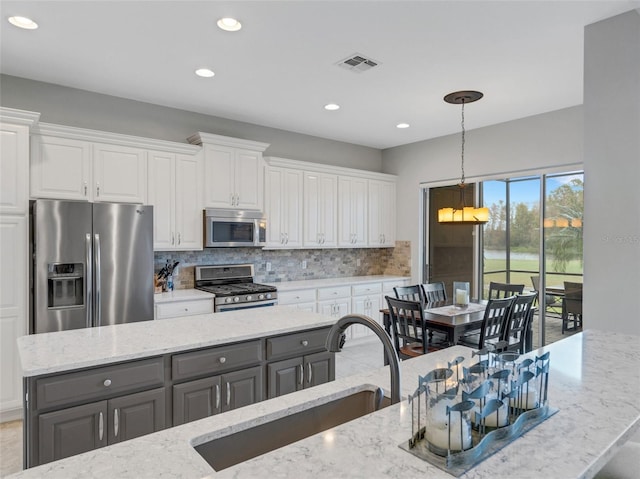 kitchen with gray cabinetry, sink, stainless steel appliances, and white cabinets