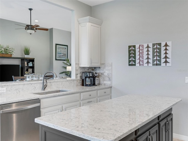 kitchen with sink, stainless steel dishwasher, white cabinets, and gray cabinetry