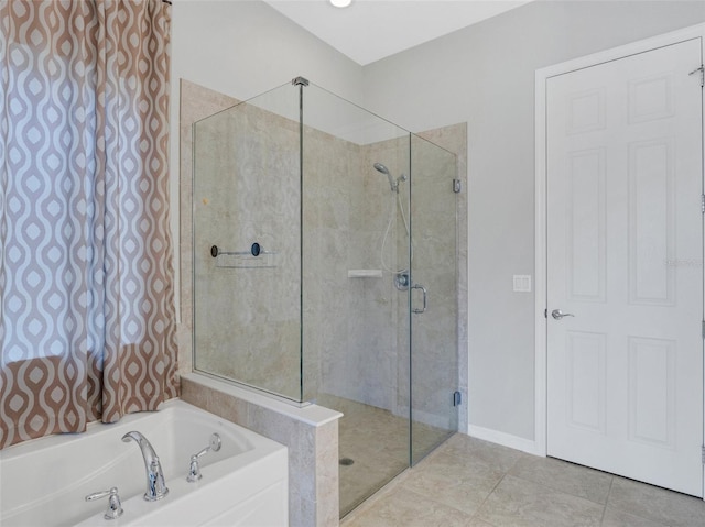 bathroom featuring tile patterned flooring and separate shower and tub