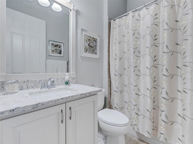 bathroom featuring walk in shower, vanity, and toilet