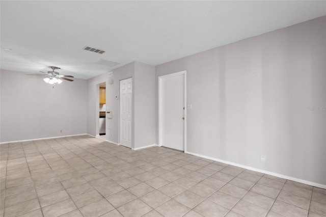 tiled spare room with ceiling fan