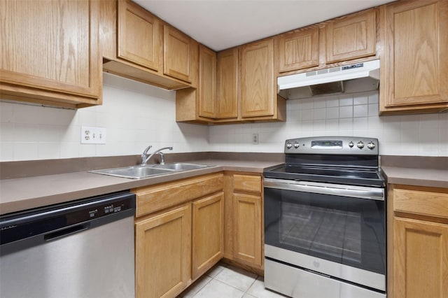 kitchen featuring stainless steel appliances, light tile patterned floors, tasteful backsplash, and sink