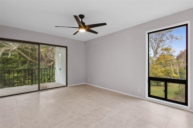 tiled spare room with ceiling fan