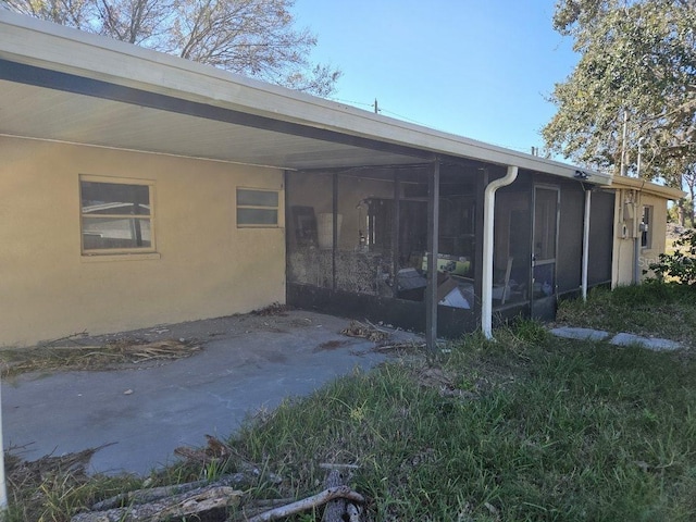 rear view of property with a sunroom