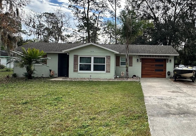 ranch-style house featuring a garage and a front lawn