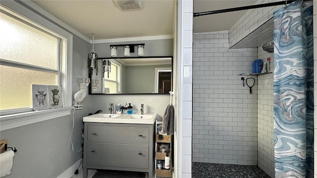 bathroom featuring curtained shower, vanity, and ornamental molding