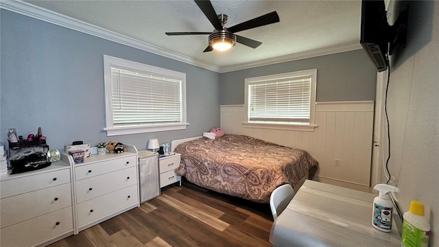 bedroom with ornamental molding, ceiling fan, and dark hardwood / wood-style flooring