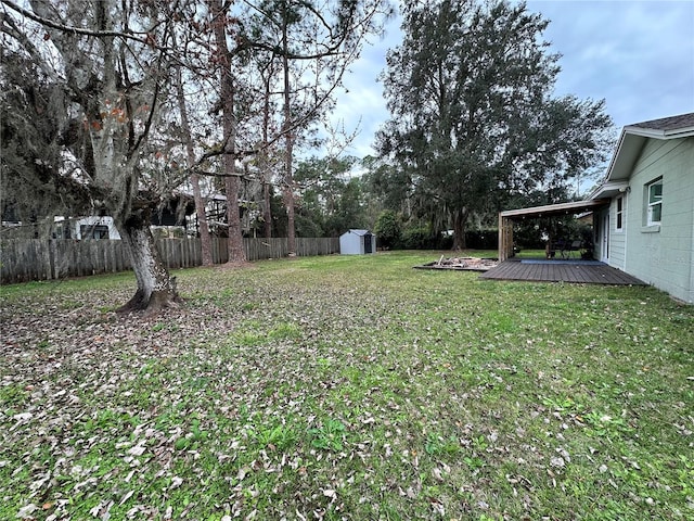 view of yard with a shed and a wooden deck