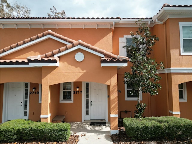 view of front of house featuring a tile roof and stucco siding