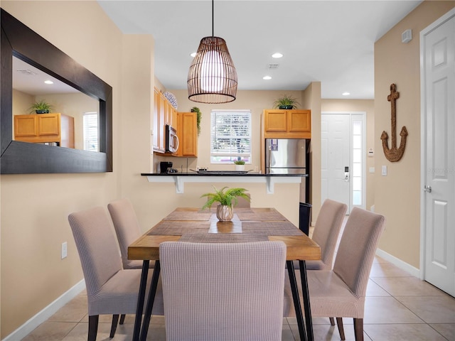 tiled dining space featuring plenty of natural light