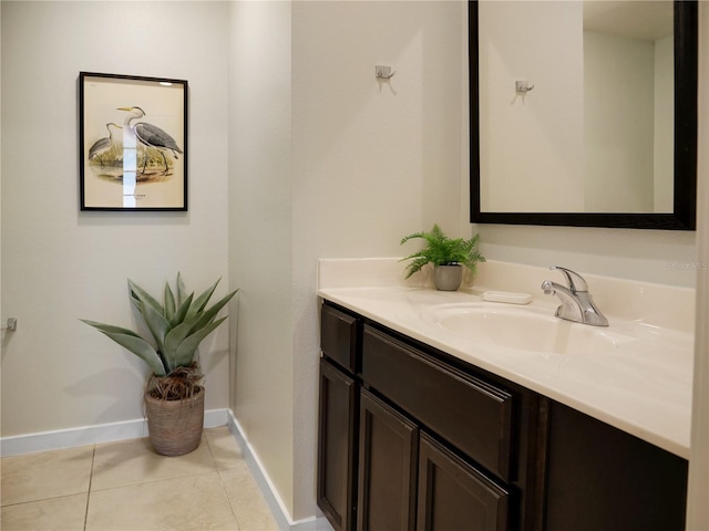 bathroom featuring vanity, baseboards, and tile patterned floors