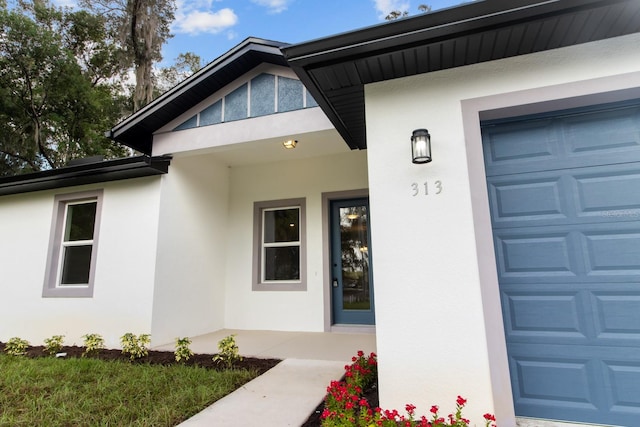 view of exterior entry featuring a garage