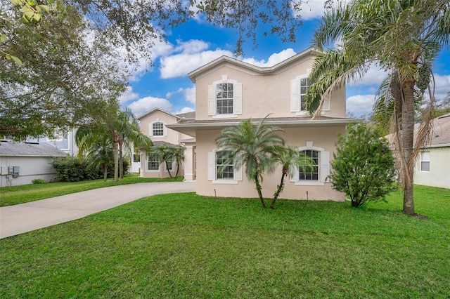 mediterranean / spanish-style home with a front lawn