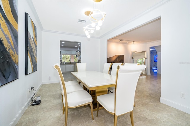 dining room with a chandelier and ornamental molding