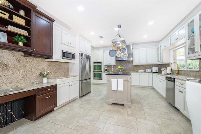 kitchen featuring decorative light fixtures, decorative backsplash, sink, and stainless steel appliances