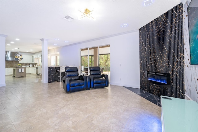 living room featuring ornamental molding and a tile fireplace