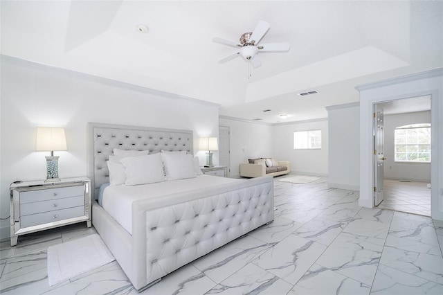 bedroom featuring ceiling fan and a tray ceiling