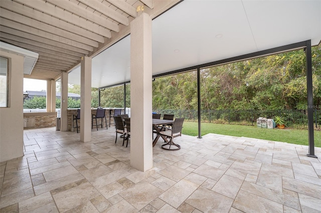 view of patio / terrace with a bar and an outdoor kitchen