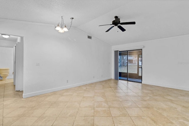 tiled spare room with vaulted ceiling, ceiling fan with notable chandelier, and a textured ceiling