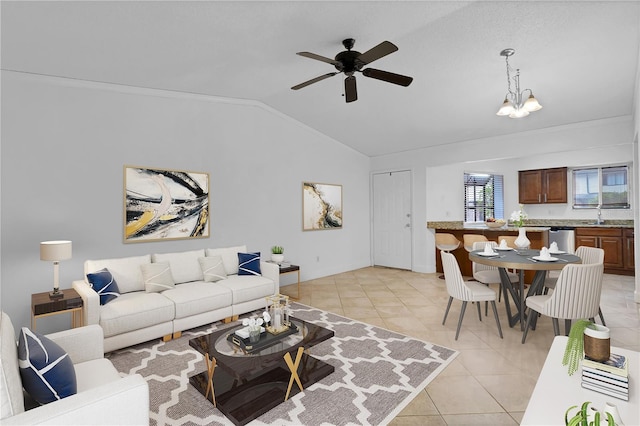 tiled living room with ceiling fan with notable chandelier, crown molding, and vaulted ceiling