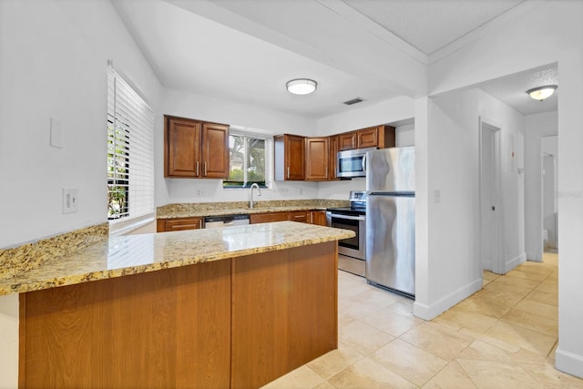 kitchen featuring stainless steel appliances, sink, ornamental molding, kitchen peninsula, and light stone counters