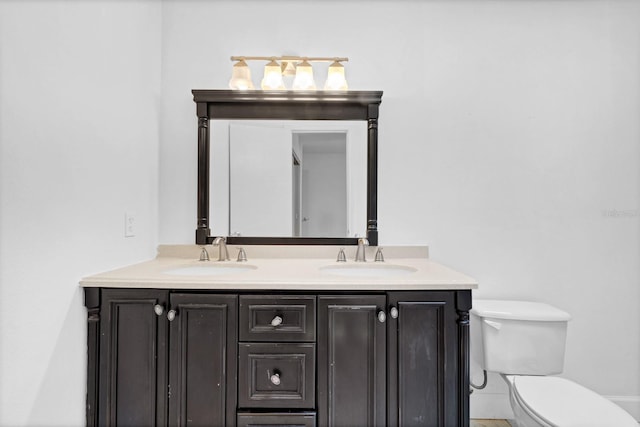 bathroom featuring toilet and vanity