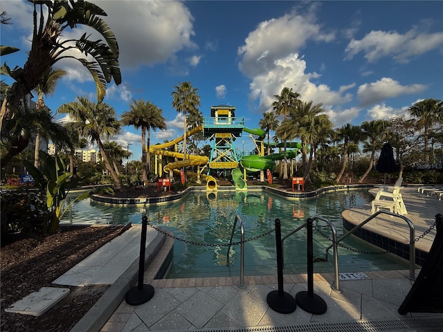 view of swimming pool featuring a playground