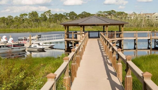 view of dock with a gazebo and a water view