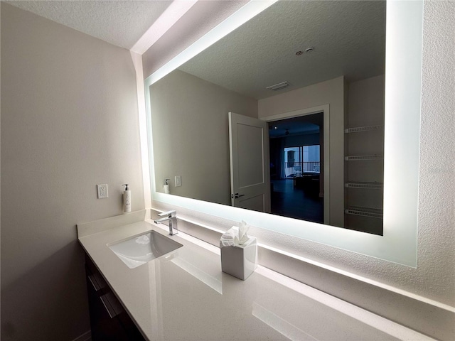 bathroom featuring vanity and a textured ceiling