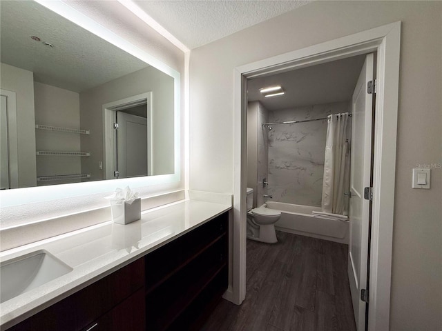 full bathroom with shower / tub combo, vanity, hardwood / wood-style flooring, and a textured ceiling