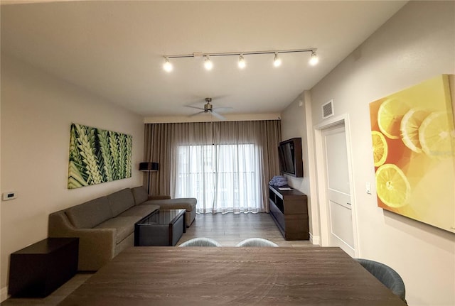 living room with dark hardwood / wood-style floors and ceiling fan