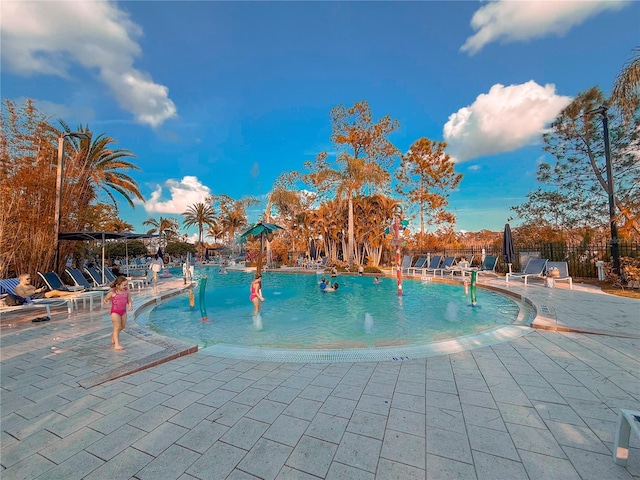 view of swimming pool featuring pool water feature and a patio