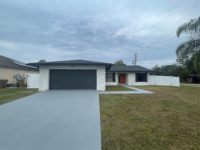 single story home with a garage and a front yard