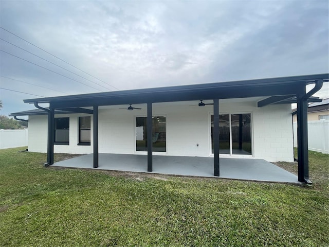 back of property featuring a yard, a patio, and ceiling fan