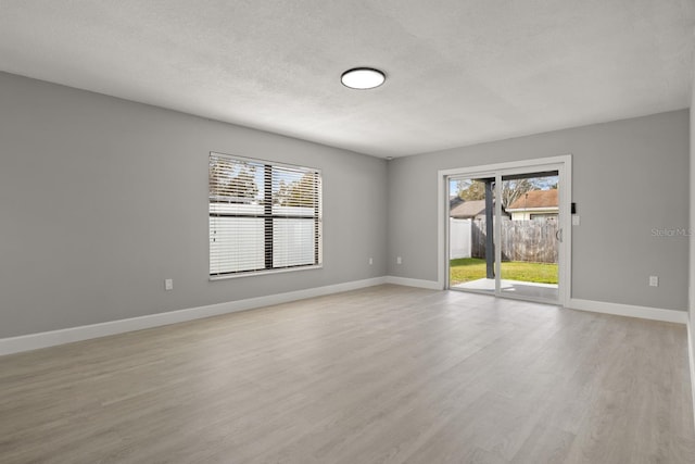 202 Cobalt Dr, Kissimmee, FL 34758 - empty room with light wood-type flooring and a textured ceiling