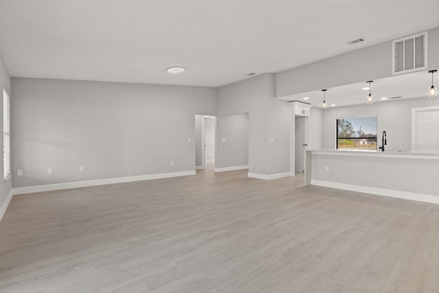 202 Cobalt Dr, Kissimmee, FL 34758 - unfurnished living room featuring light wood-style floors and recessed lighting