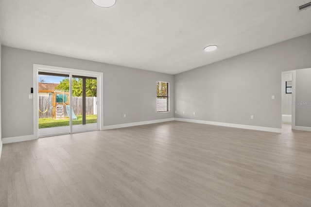 202 Cobalt Dr, Kissimmee, FL 34758 - unfurnished living room featuring light wood finished floors and plenty of natural light