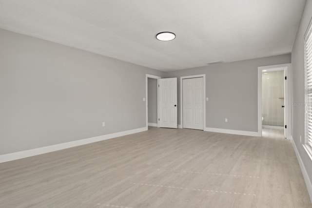202 Cobalt Dr, Kissimmee, FL 34758 - unfurnished bedroom with light wood finished floors, a closet, and ensuite bathroom