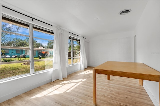 unfurnished sunroom featuring a healthy amount of sunlight and vaulted ceiling