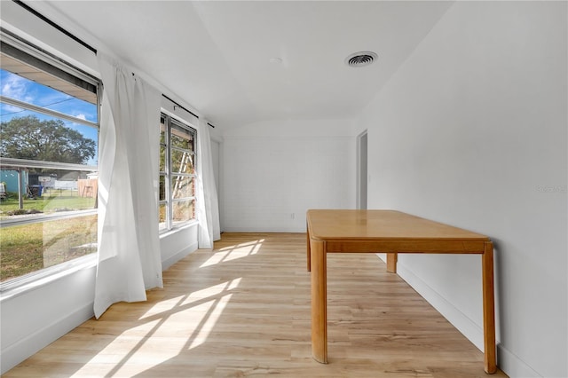 unfurnished sunroom with vaulted ceiling