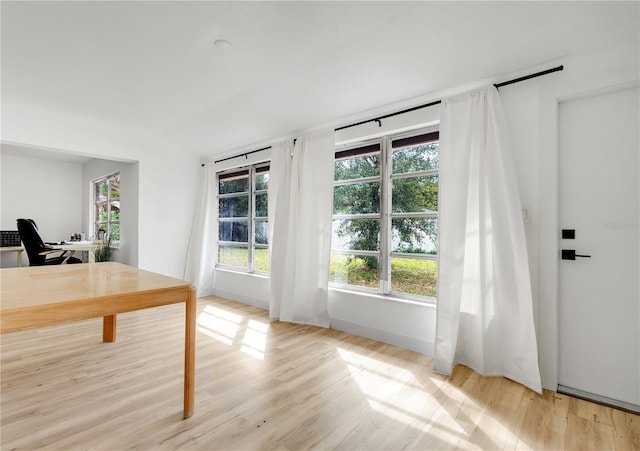 unfurnished office with light wood-type flooring and a healthy amount of sunlight