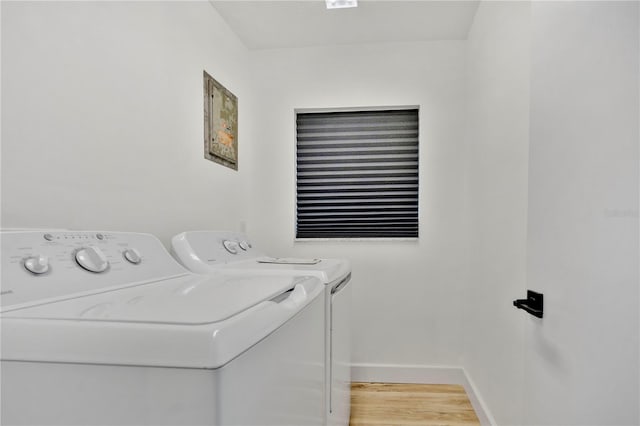 clothes washing area featuring hardwood / wood-style floors and independent washer and dryer