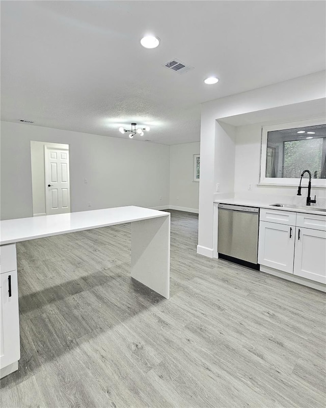 kitchen with white cabinets, dishwasher, and sink