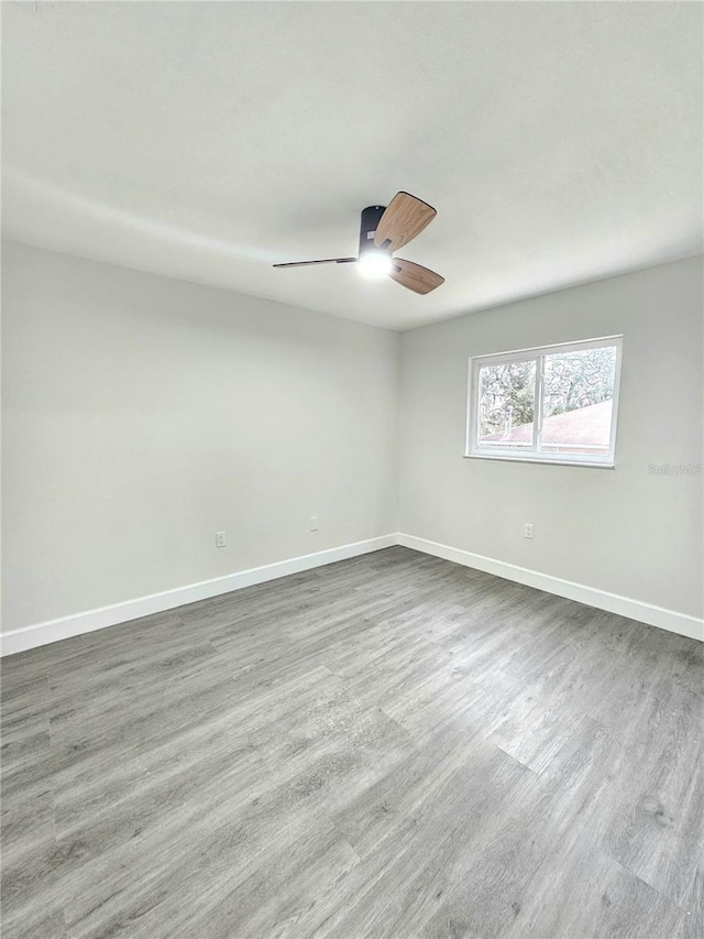 empty room with ceiling fan and hardwood / wood-style floors