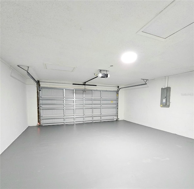 garage with a garage door opener and electric panel